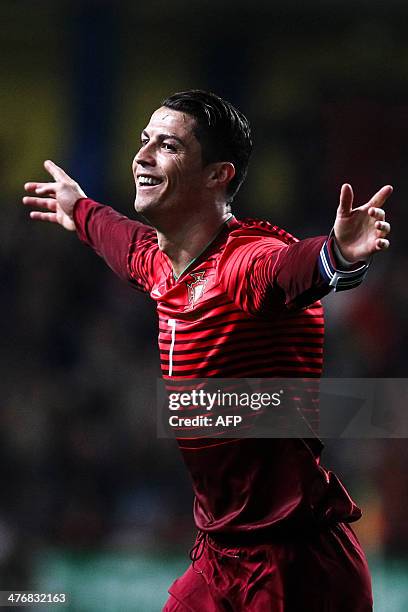 Portugal's forward Cristiano Ronaldo celebrates after scoring during the FIFA 2014 World Cup friendly football match Portugal vs Cameroon at...