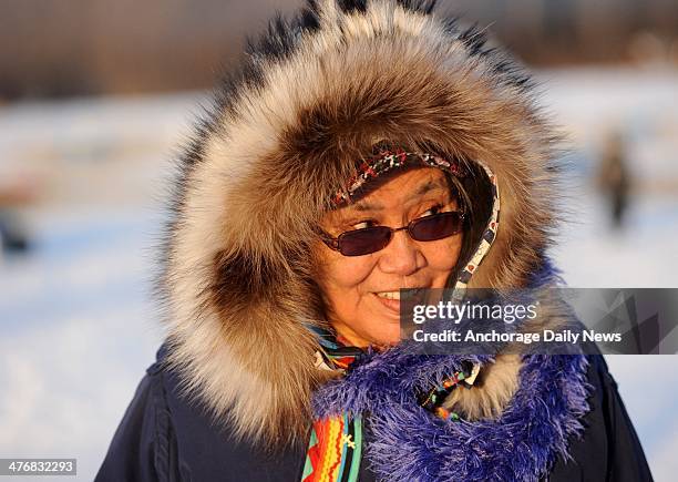 Nikolai resident Oline Petruska talks with visitors at the Nikolai checkpoint during the 2014 Iditarod Trail Sled Dog Race at sunrise on Wednesday,...