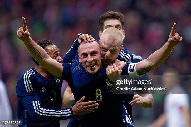 Scott Brown of Scotland celebrates with team mates after scoring the only goal of the match during the international friendly soccer match between...