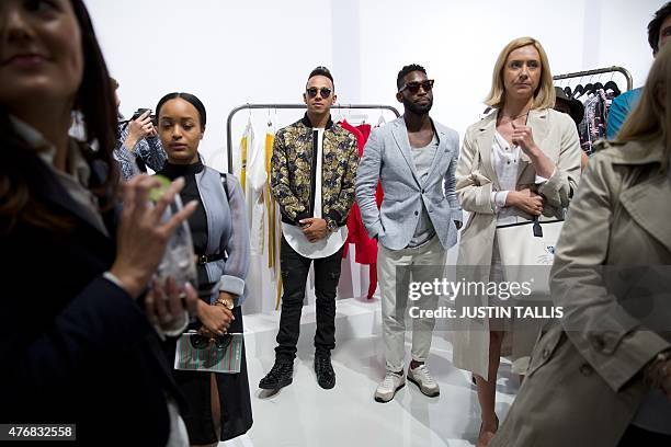 British Formula One racing driver Lewis Hamilton and British musician Tinie Tempah attend a special event to officially open the Spring/Summer 2016...