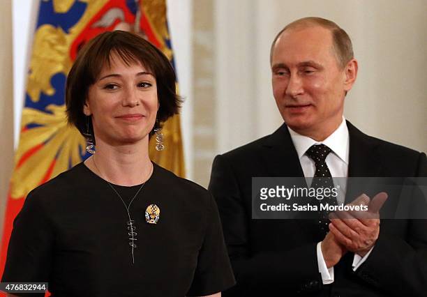 Russian President, Vladimir Putin applauds Russian actress and co-founder of the children's charity Give Life, Chulpan Khamatova during a...