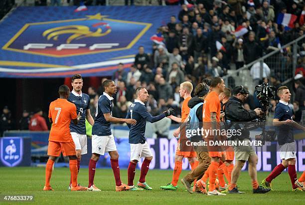 France's and Netherlands' players shake hands at the end of the during a friendly football match between France and Netherlands at the Stade de...