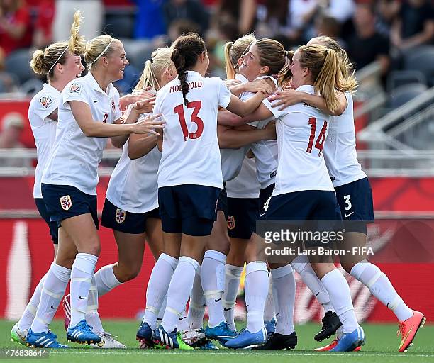 Maren Mjelde of Norway celebrates with team mates after scoring her teams first goal during the FIFA Women's World Cup 2015 Group B match between...