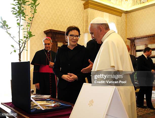 Pope Francis exchanges gifts with the Prime Minister of Poland, Ewa Kopacz during an audience at the Apostolic Palace on June 12, 2015 in Vatican...