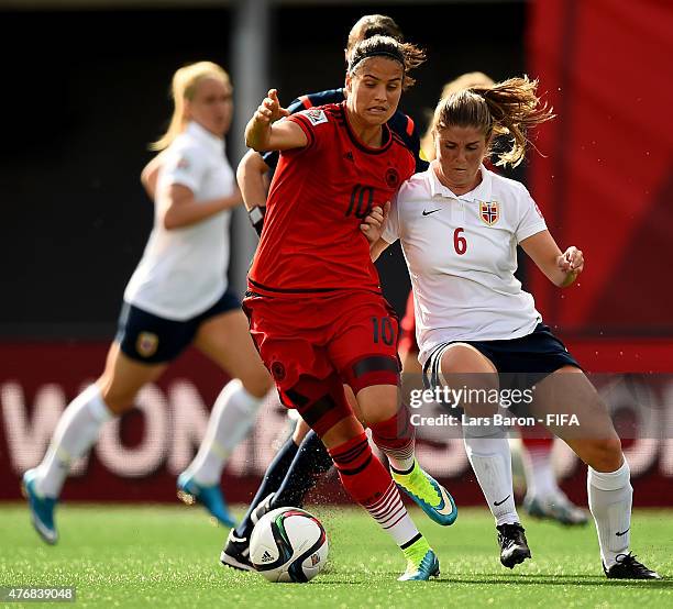 Dzsenifer Marozsan of Germany is challenged by Maren Mjelde of Norway during the FIFA Women's World Cup 2015 Group B match between Germany and Norway...