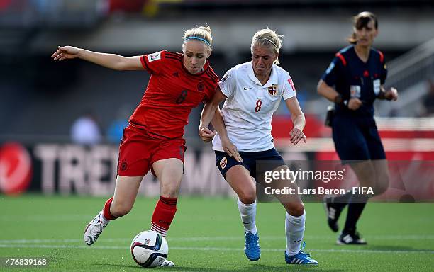 Pauline Bremer of Germany is challenged by Solveig Gulbrandsen of Norway during the FIFA Women's World Cup 2015 Group B match between Germany and...