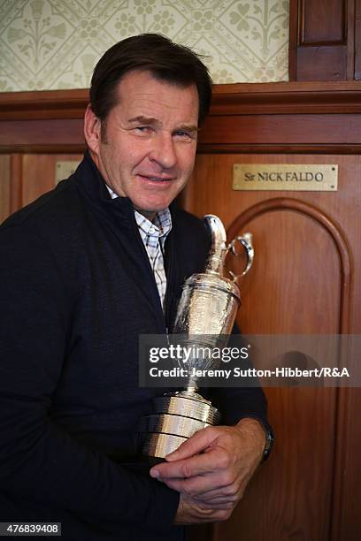 Sir Nick Faldo, golfer and three times winner of the Open Championship, with his Open Championship winner's Claret Jug, stands beside his locker in...