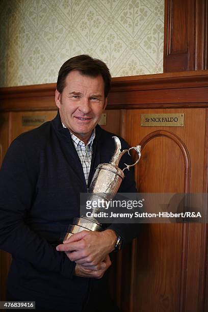Sir Nick Faldo, golfer and three times winner of the Open Championship, with his Open Championship winner's Claret Jug, stands beside his locker in...