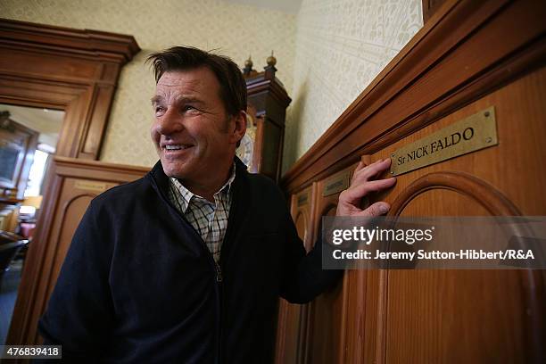 Sir Nick Faldo, golfer and three times winner of the Open Championship, with his Open Championship winner's Claret Jug, stands beside his locker in...