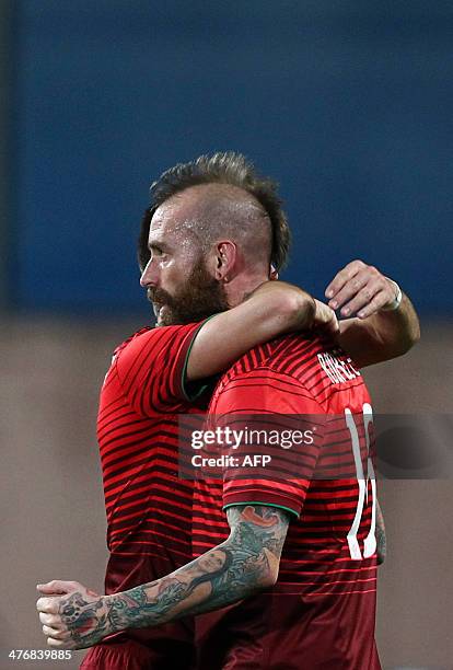 Portugal's midfielder Raul Meireles celebrates with a teammate after scoring during the FIFA 2014 World Cup friendly football match Portugal vs...