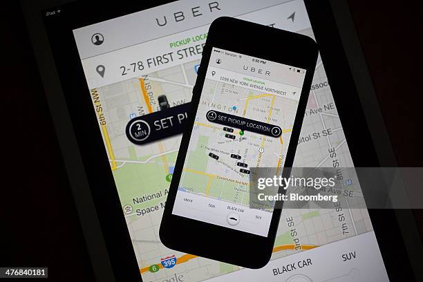 The Uber Technologies Inc. Application is displayed on an Apple Inc. IPhone 5s and iPad Air in this arranged photograph in Washington, D.C., U.S., on...