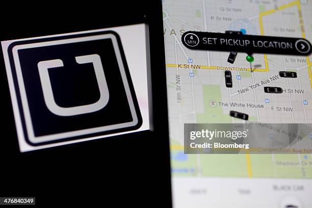 The Uber Technologies Inc. Application and logo are displayed on an Apple Inc. IPhone 5s and iPad Air in this arranged photograph in Washington,...