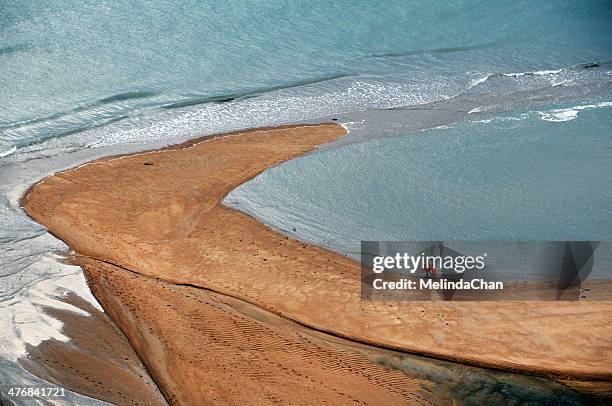 lady walking on the mudflats - mud flat stock pictures, royalty-free photos & images