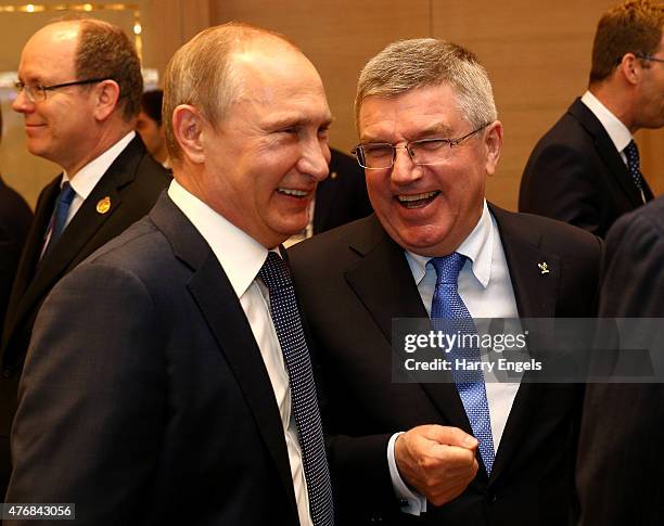 Russian President Vladimir Putin chats with IOC President Thomas Bach during the Opening Ceremony for the Baku 2015 European Games at the Olympic...