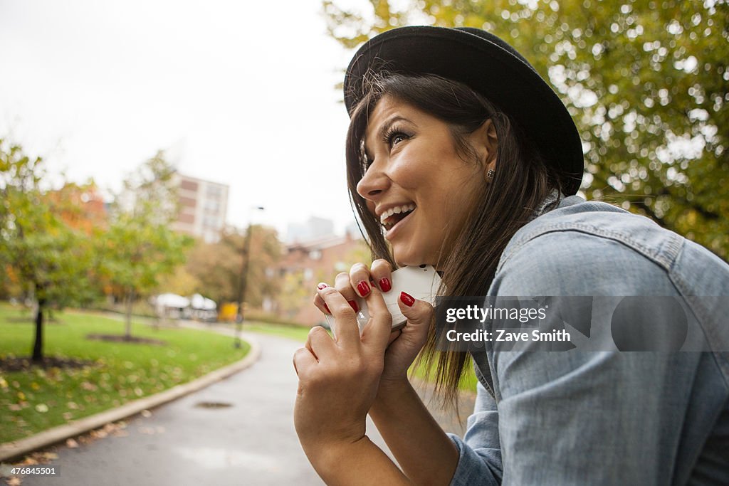 Woman holding cellular phone to chin