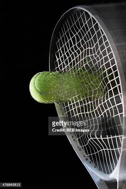 close up tennis racket hitting ball with blurred motion - tennis ball fotografías e imágenes de stock