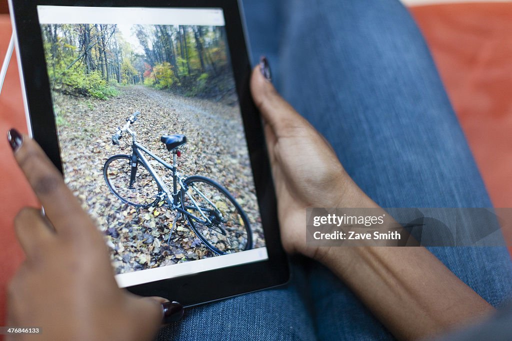 Cropped image of young woman using digital tablet