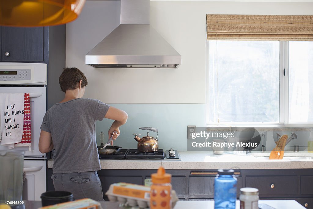 Mature woman preparing food in kitchen