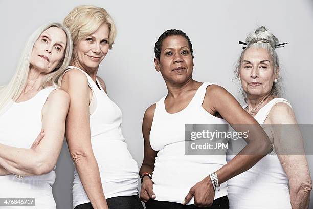 studio portrait of senior women friends posing for camera - mature woman beauty stock pictures, royalty-free photos & images