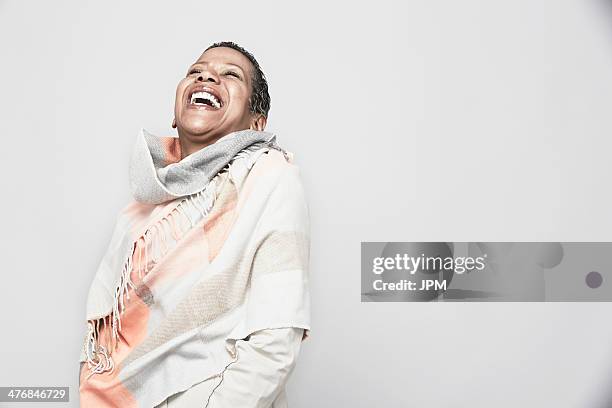 studio portrait of mature woman laughing - shawl foto e immagini stock