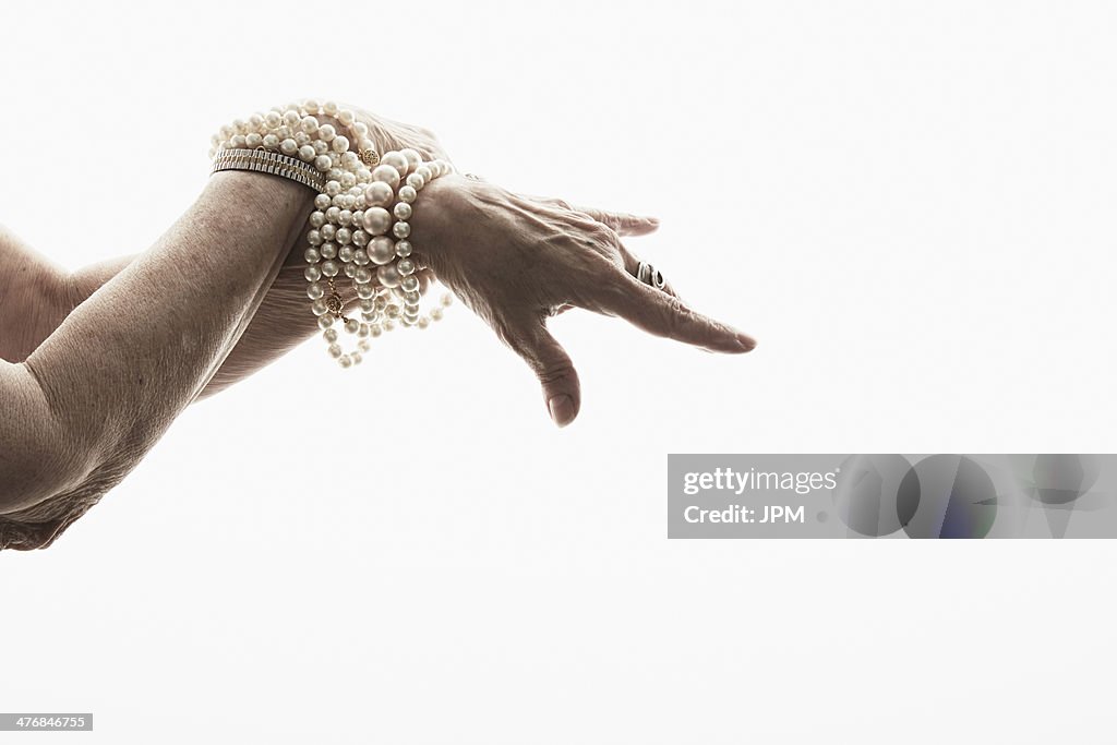 Studio shot of mature woman's hands wearing jewelry