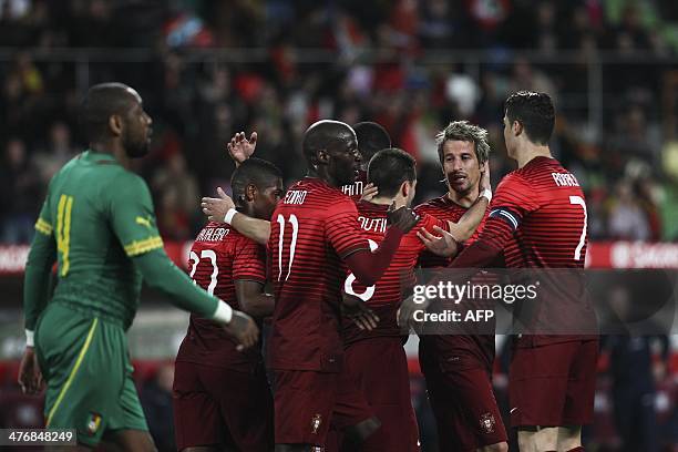 Portugal's defender Fabio Coentrao celebrates with his teammates after scoring during the FIFA 2014 World Cup friendly football match Portugal vs...