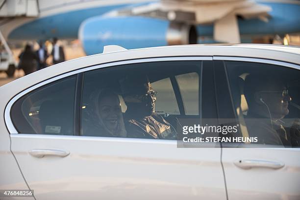 Chad President Idriss Deby Itno and his wife Hinda sit in a car after arriving at the Waterkloof Air Force base in Pretoria on June 12, 2015. Heads...