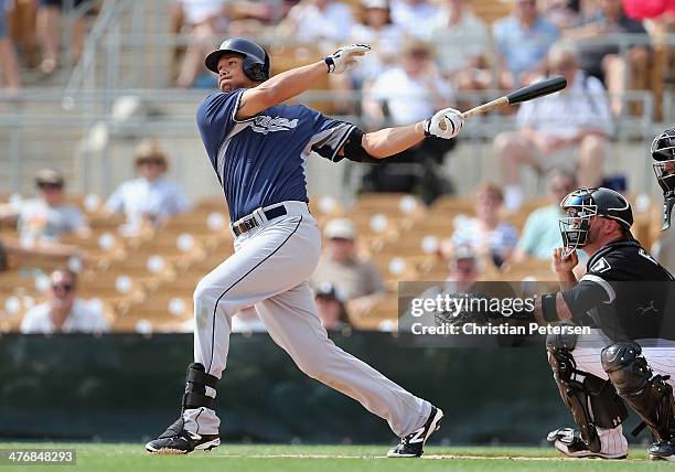 Kyle Blanks of the San Diego Padres hits a single against the Chicago White Sox during the first inning of the spring training game at Camelback...