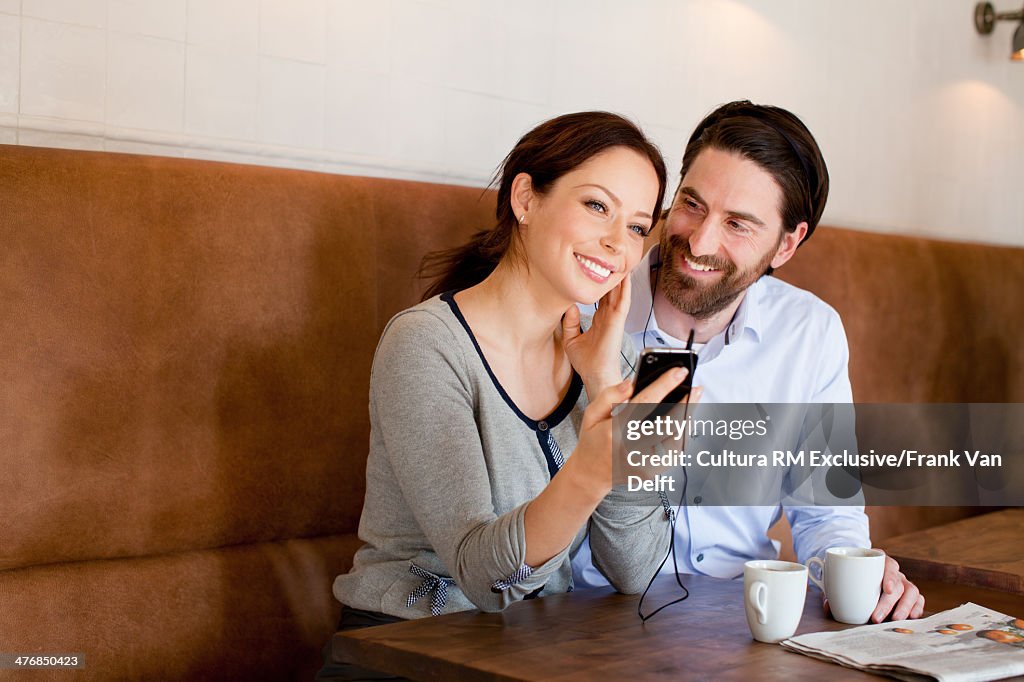 Couple with smartphone and earphones