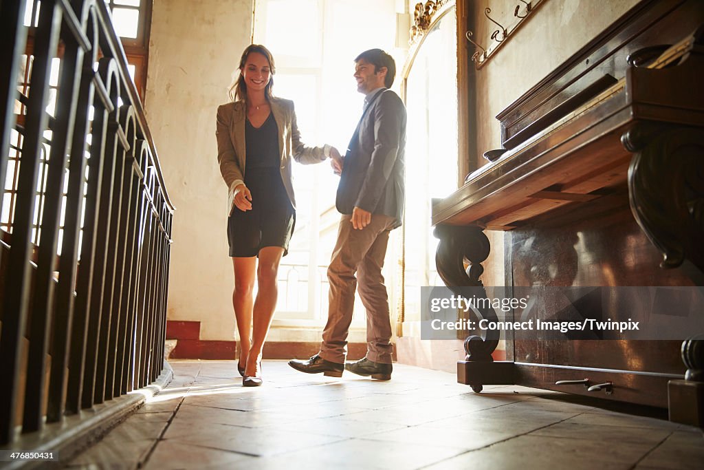 Couple holding hands in hotel lobby