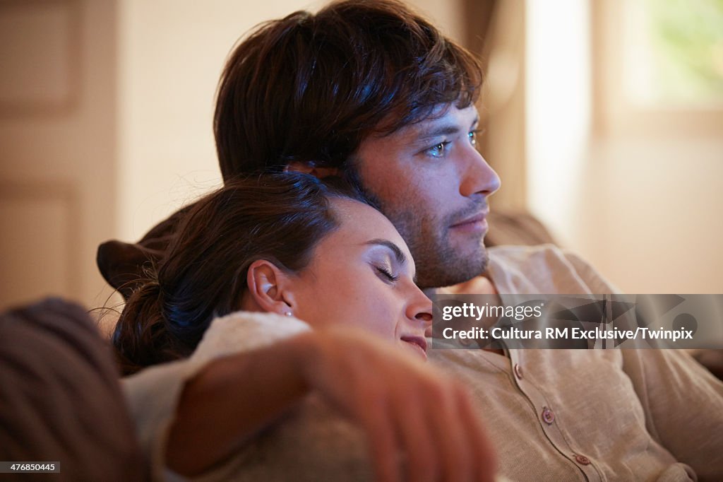 Portrait of happy couple relaxing on sofa