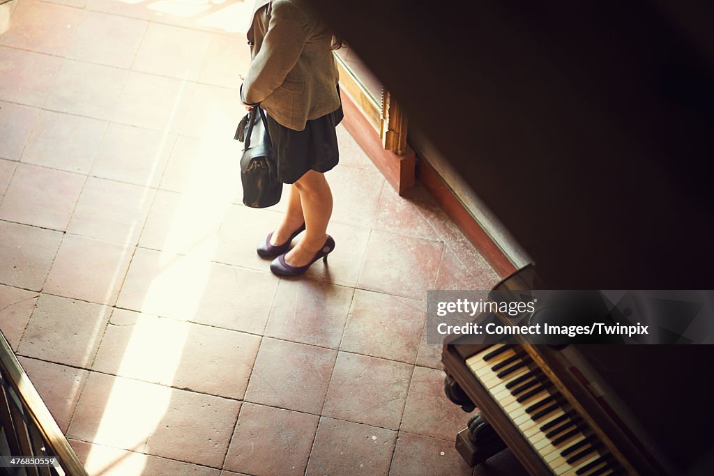Young woman waiting in hotel lobby