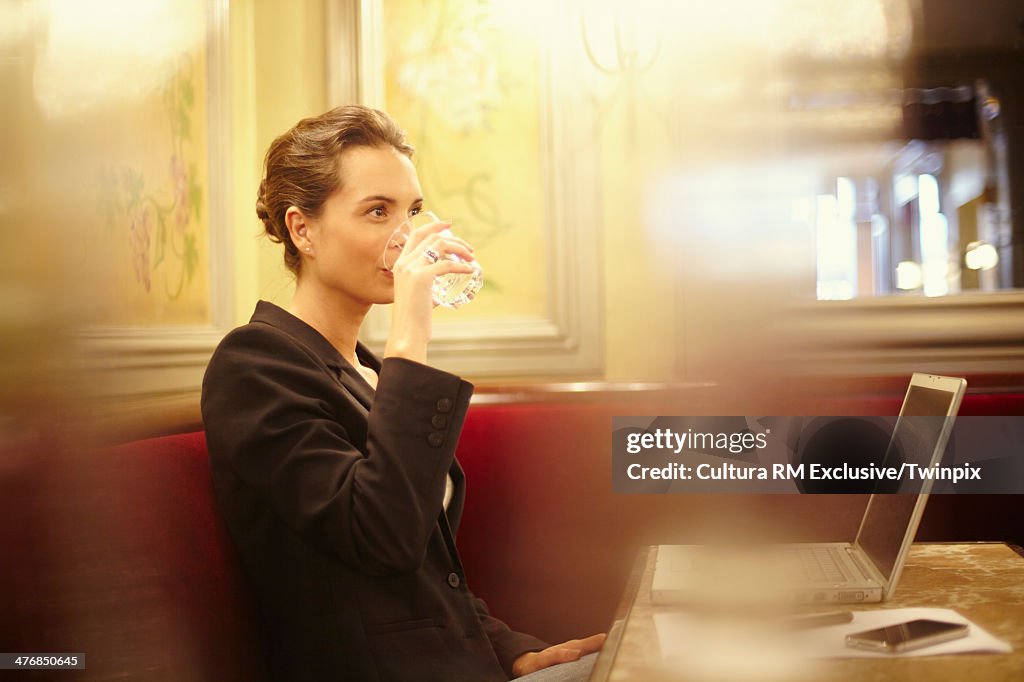 Young businesswoman in cafe with laptop