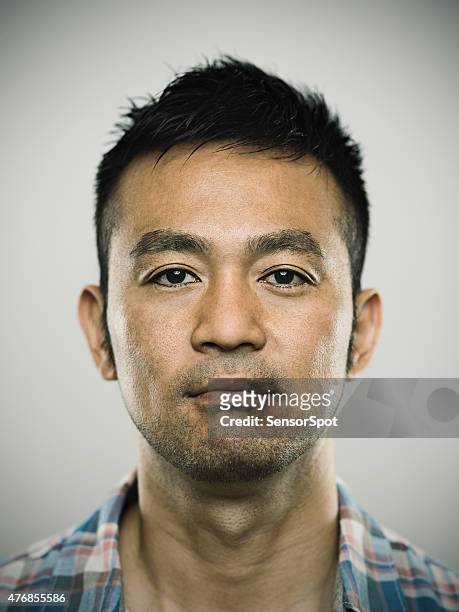 portrait of a young japanese man looking at camera - blank expression stock pictures, royalty-free photos & images