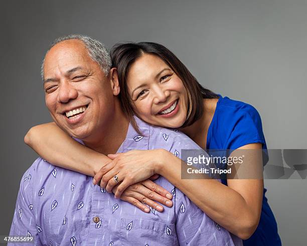 adult daughter hugging mature father, smiling - family on coloured background stock pictures, royalty-free photos & images