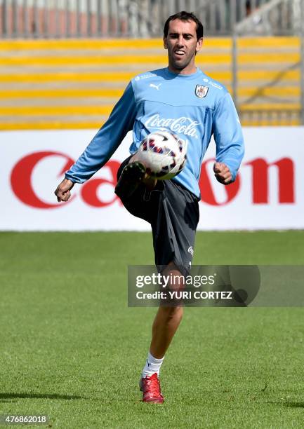 Uruguay's defender Diego Godin gets familiar with the pitch of the Calvo & Bascunan stadium in Antofagasta, Chile, on June 12 on the eve of their...
