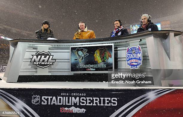 Network hosts Kathryn Tappen, Barry Melrose, Jamie McLennan and Jamal Mayers look on from the broadcast booth during the 2014 NHL Stadium Series game...