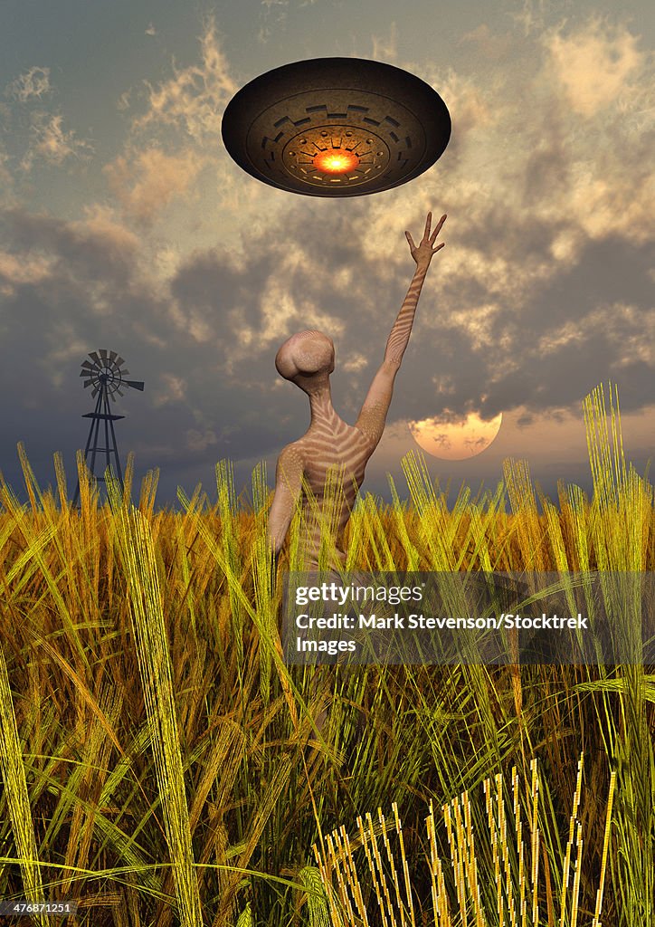 An alien being directing a UFO in making crop circles.