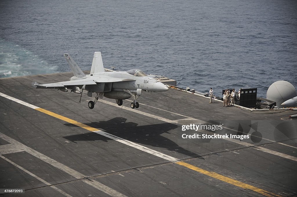 Gulf of Oman, July 12, 2013 - An F/A-18E Super Hornet lands on the aircraft carrier USS Nimitz.