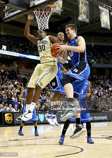 Marshall Plumlee of the Duke Blue Devils battles for a rebound against Travis McKie of the Wake Forest Demon Deacons during their game at Joel...