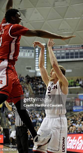 Connecticut Huskies guard/forward Niels Giffey gets kicked in the groin by Rutgers Scarlet Knights forward/center Kadeem Jack after taking a three...