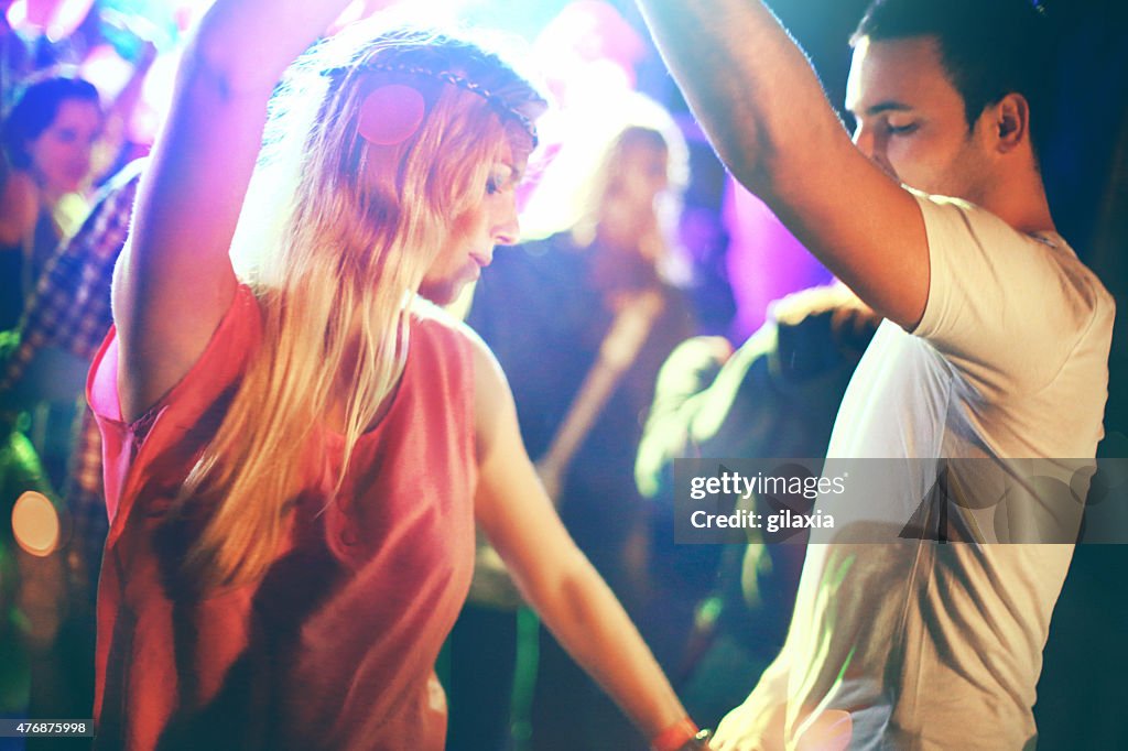 Two people dancing at concert.