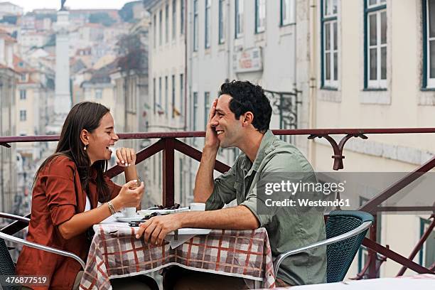 portugal, lisboa, carmo, largo du duque, young couple sitting at street cafe - lisbon tourist stock pictures, royalty-free photos & images