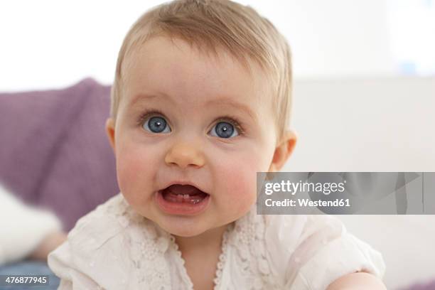 portrait of baby girl with open mouth showing first teeth - girls open mouth imagens e fotografias de stock