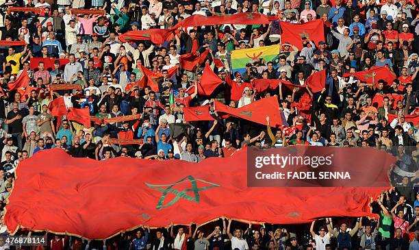Maroccan supporters hold flags during the 2017 Africa Cup of Nations qualifying football match against Libya in Agadir on June 12, 2015. AFP PHOTO /...