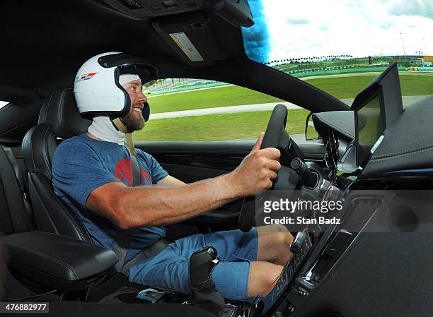 Graham DeLaet of Canada races around the track during the Cadillac V-Series Challenge driving experience at the Homestead-Miami Speedway for the...