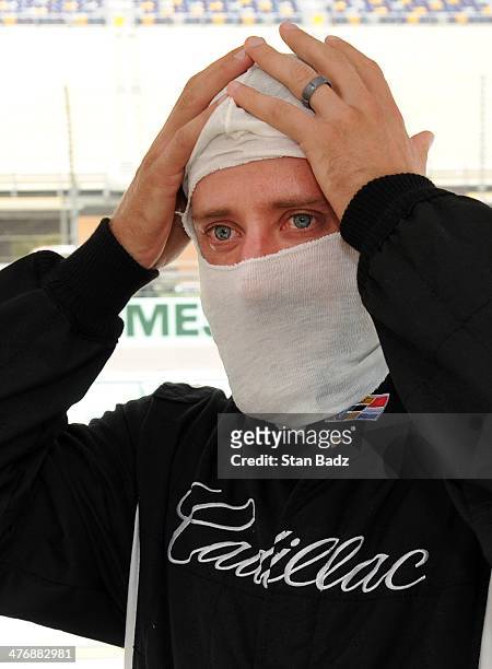Graham DeLaet of Canada suits up during the Cadillac V-Series Challenge driving experience at the Homestead-Miami Speedway for the World Golf...