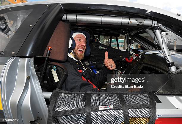 Graham DeLaet of Canada gives a thumbs up during the Cadillac V-Series Challenge driving experience at the Homestead-Miami Speedway for the World...