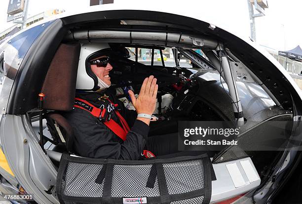 Hunter Mahan prepares to ride along in the Cadillac V-Series Challenge driving experience at the Homestead-Miami Speedway for the World Golf...