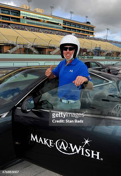 Hunter Mahan prepares to drive in the Cadillac V-Series Challenge driving experience at the Homestead-Miami Speedway for the World Golf...